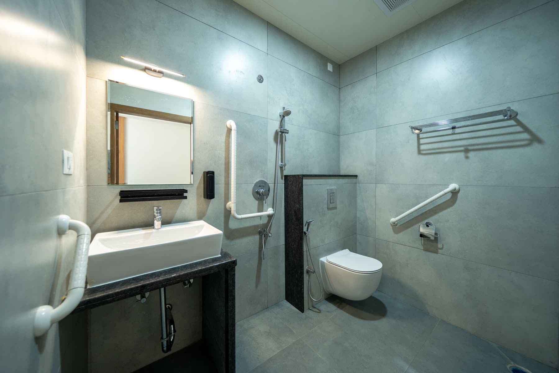 Accessible bathroom with grab bars, walk-in shower and wheelchair-friendly design
