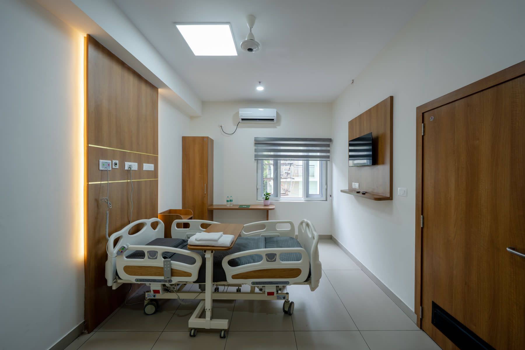 Premium private patient room with adjustable hospital bed and modern amenities